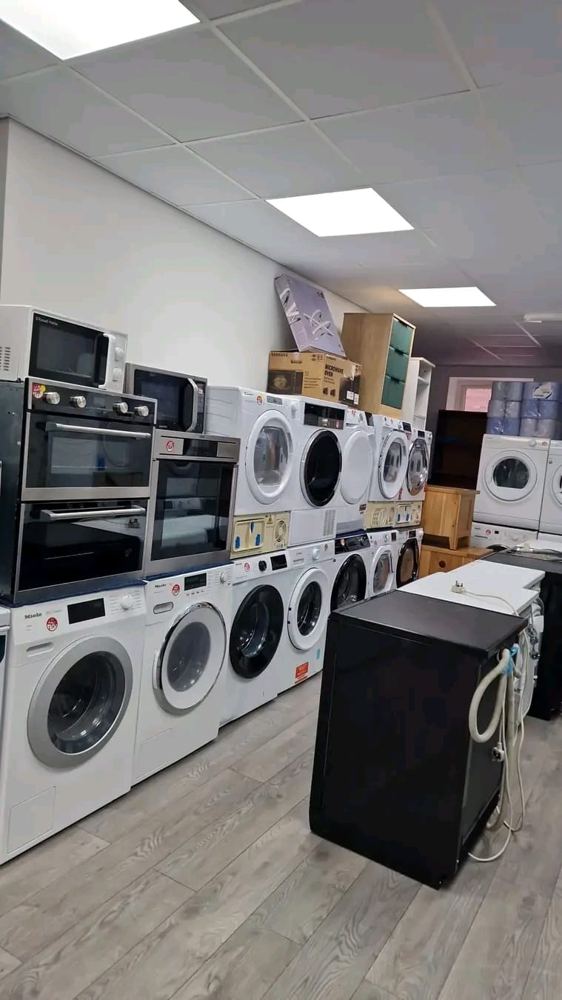 Rows of repaired washing machines, dryers, ovens and microwaves