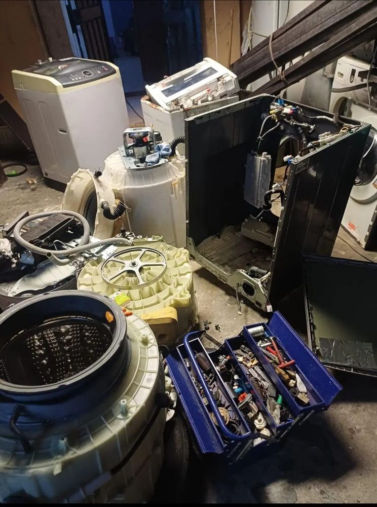 Workshop with appliance parts and a toolbox